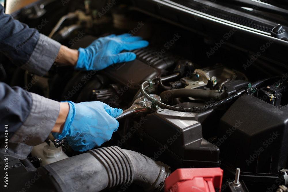 Checking the engine, Mechanic fixing the engine, Copy-space. Checking the engine, Mechanic fixing the engine, Copy-space.