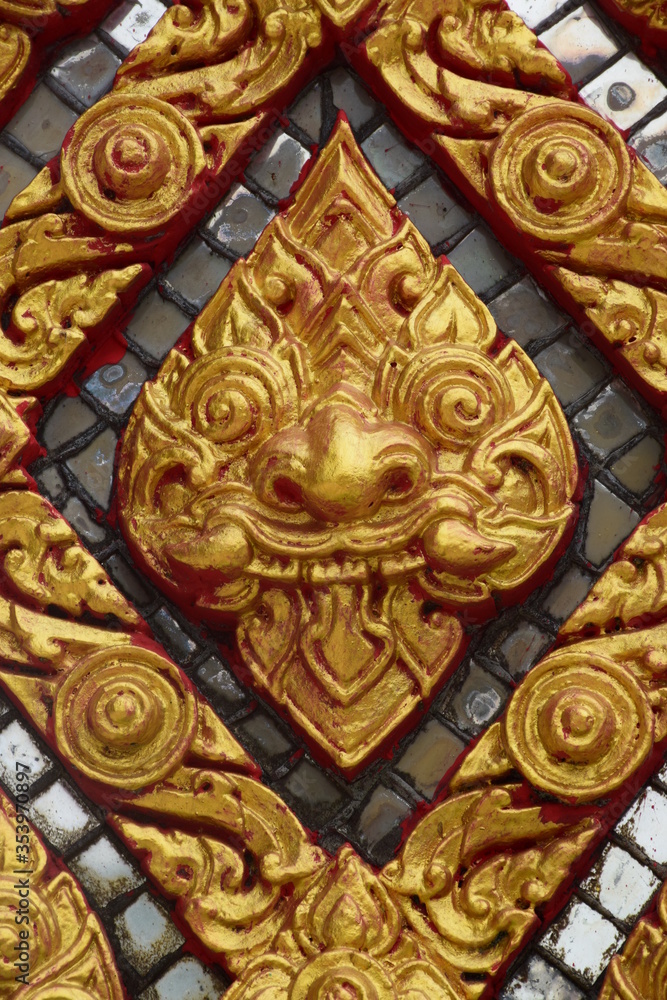 Golden painted Thai temple wall