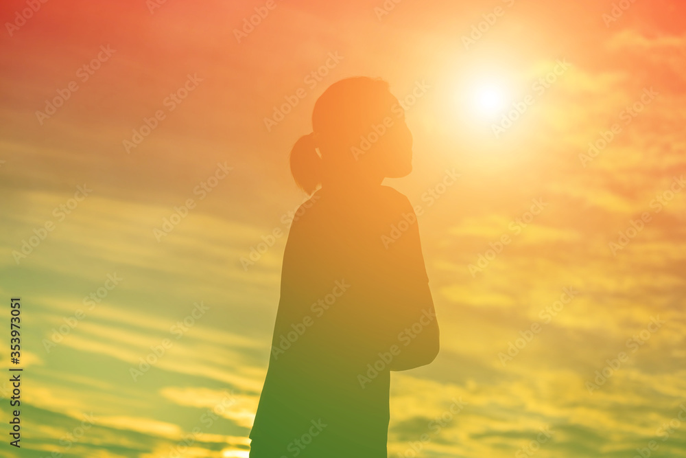 silhouette of a young woman standing alone