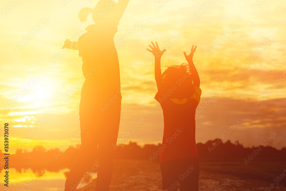 Mother encouraged her daughter out of the shadows at sunset. Mother encouraged her daughter out of the shadows at sunset.