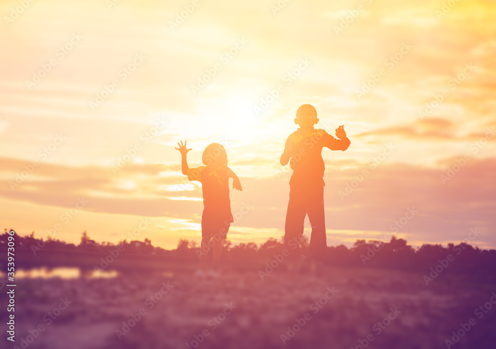 Fototapeta premium kid silhouette,Moments of the child's joy. On the Nature sunset