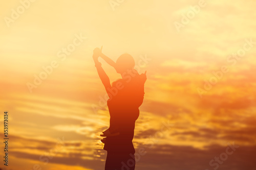 Mother encouraged her daughter out of the shadows at sunset.