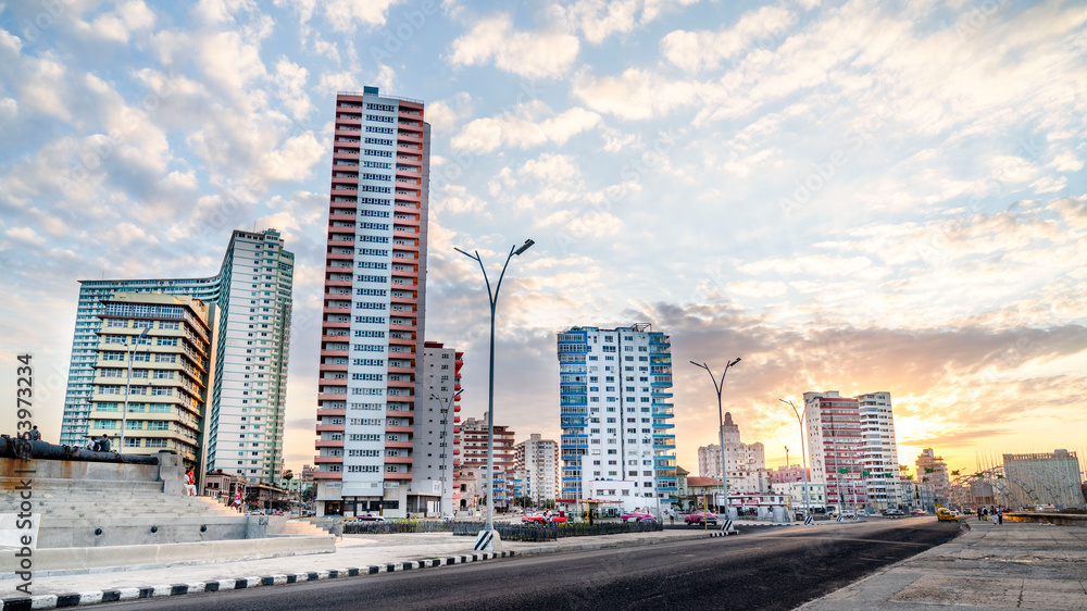 03. 03. 2020. Havana, Cuba. Sunset over the streets of the vibrant city along the sea side road also know as El Malecon. 03. 03. 2020. Havana, Cuba. Sunset over the streets of the vibrant city along the sea side road also know as El Malecon.