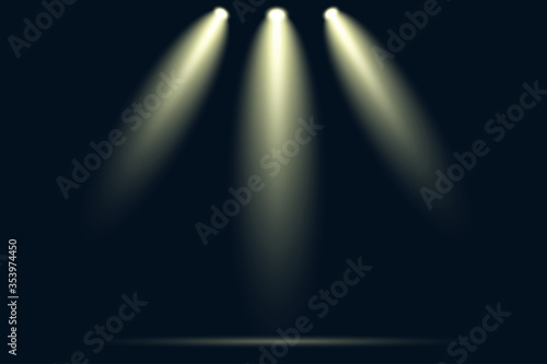 Three spotlights shining down on empty dark stage with dramatic yellow light beams and smoke effect