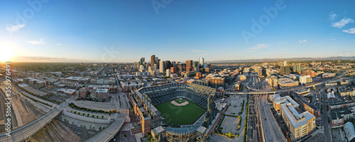 city skyline of denver during sunrise with baseball field