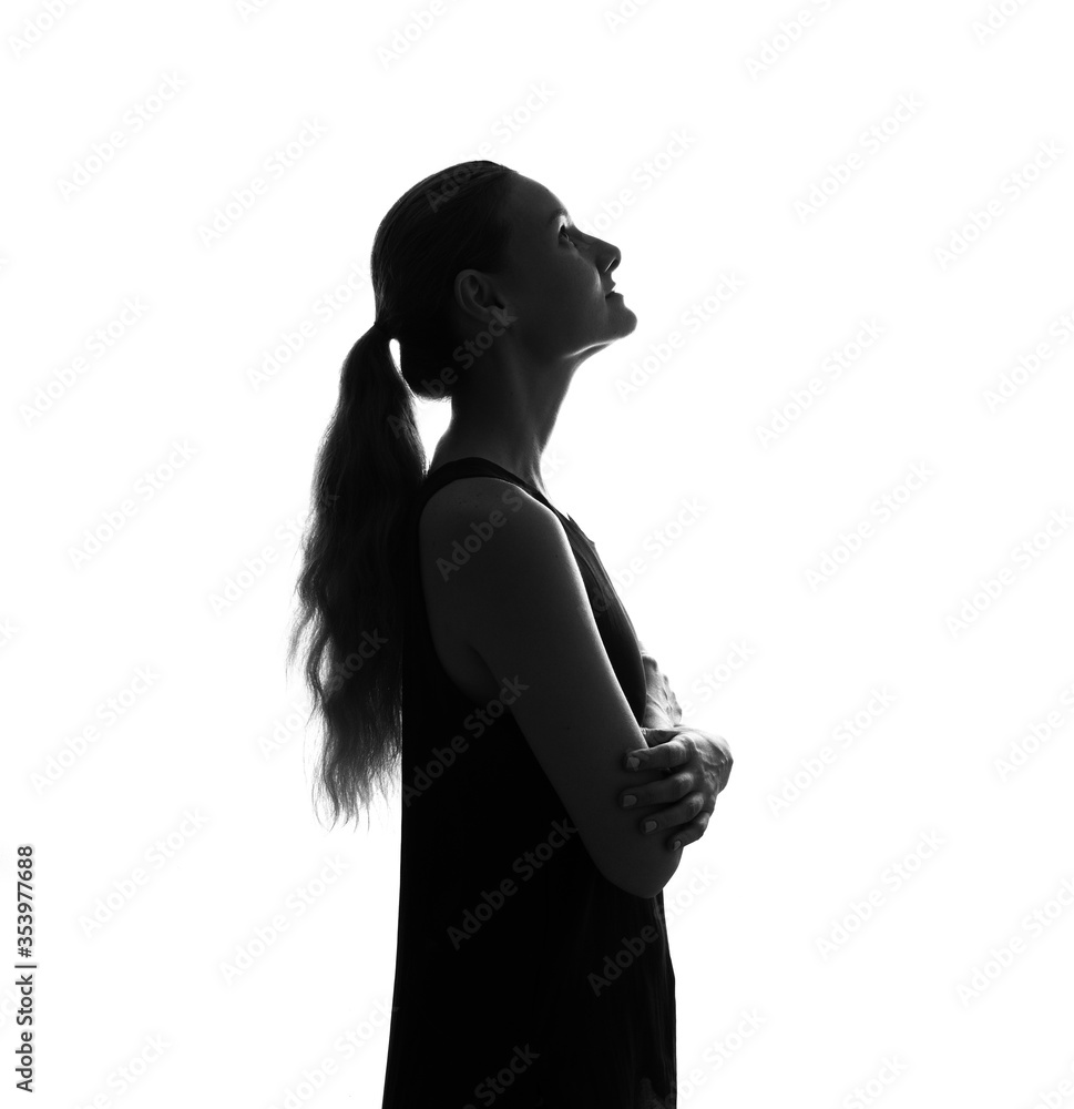 Female person silhouette in the shadow, back lit light Female person silhouette in the shadow, back lit light