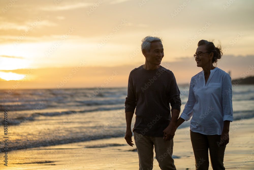 Fototapeta premium Senior of couple holding hands and walking together each other talking happily. Love is everything Retirement age concept and love, copy space for text