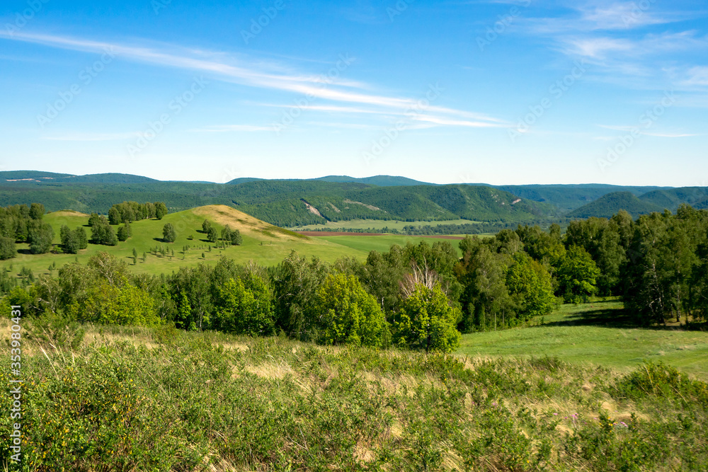 Spring mountain landscape overgrown with green forest. Panorama. Ural mountains.