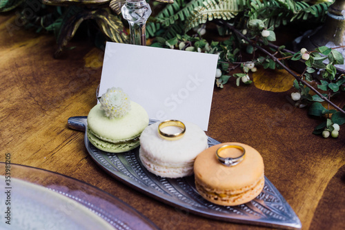 Business card presentation with macaron cookies and rings photo