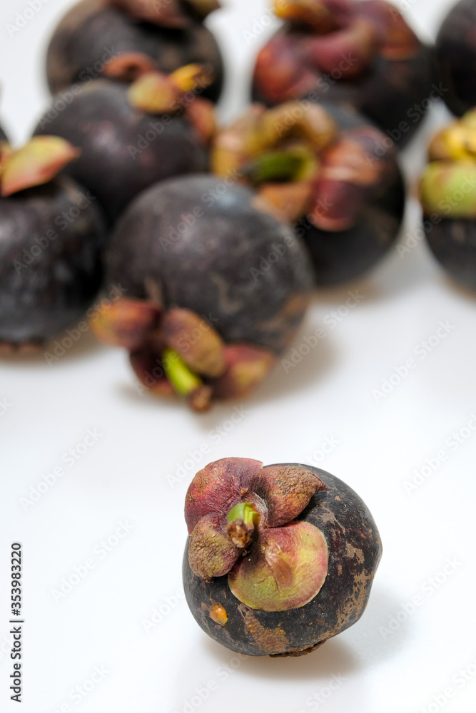 Close-Up Of Mangosteen Fruits On Table Close-Up Of Mangosteen Fruits On Table