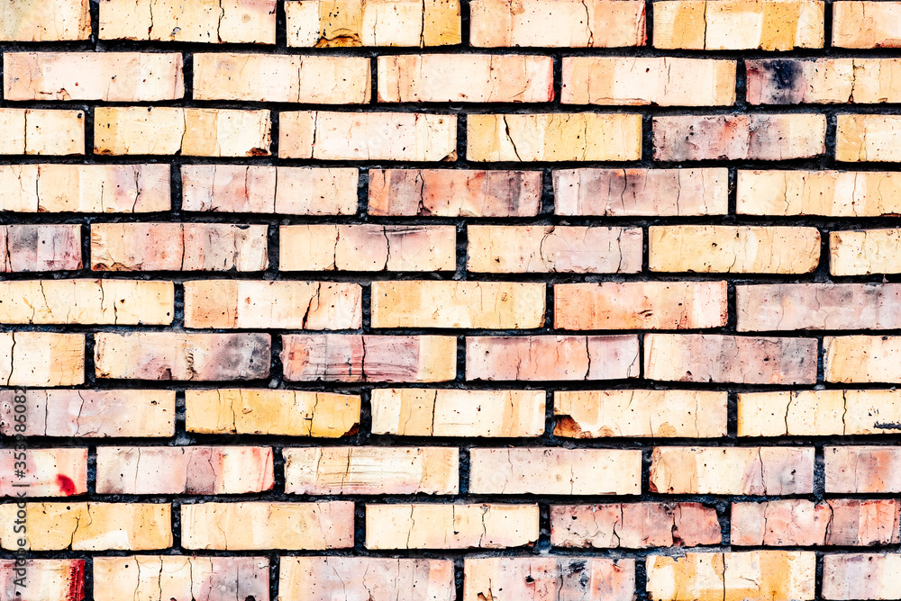 Fototapeta premium Weathered texture of stained old orange and white brick wall background