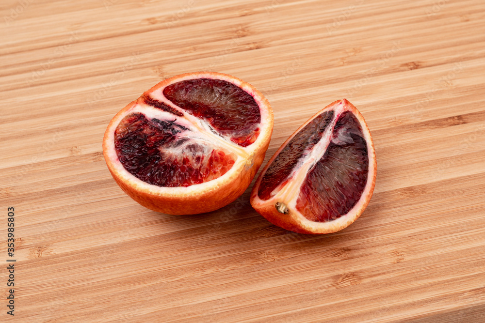Bloody orange on a wooden surface side view close-up Bloody orange on a wooden surface side view close-up