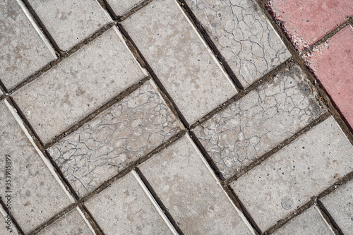 Background image of texture of pedestrian footpath covered by paving tiles