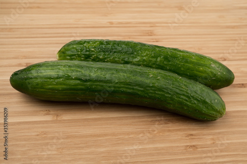 Green cucumber on a wooden background