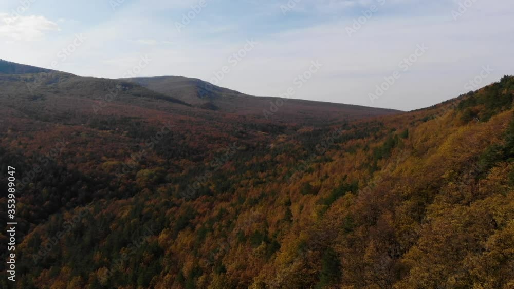 Droning over autumn hilly terrain. Air shooting. View from above. Beautiful autumn picture of the Russian foothills of the Caucasus. Flight of the drone. Droning over autumn hilly terrain. Air shooting. View from above. Beautiful autumn picture of the Russian foothills of the Caucasus. Flight of the drone.