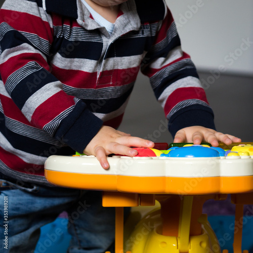 child playing pressing the buttons of his electronic game