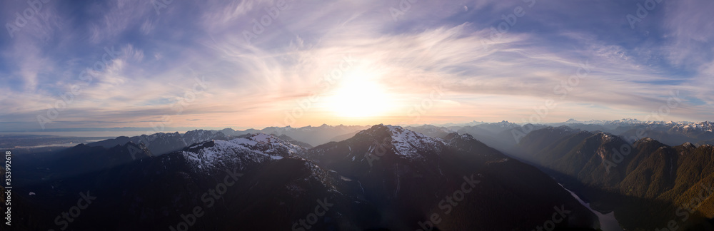 Aerial Panoramic View of Canadian Mountain Landscape during a colorful sunset. Located North of Vancouver, British Columbia, Canada. Nature Background Panorama