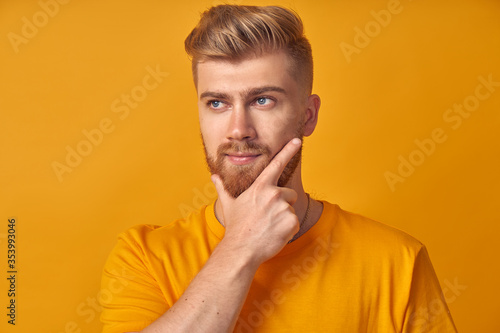 Cheerful positive caucasian man smiles and shows ok sign with both hands, demonstrates that everything is fine, shows his approval, gestures on yellow background. The concept of good delivery service
