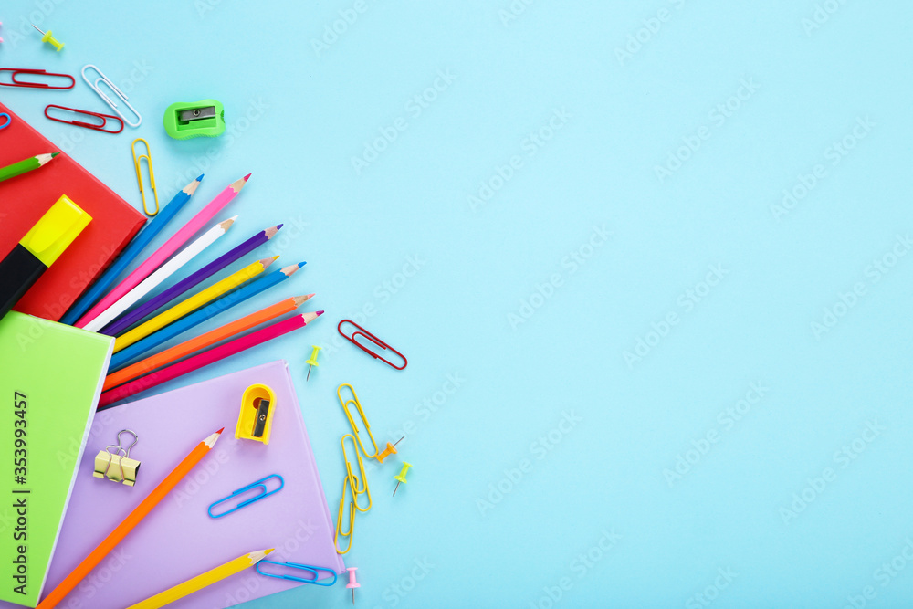 Fototapeta premium Different school supplies on blue background