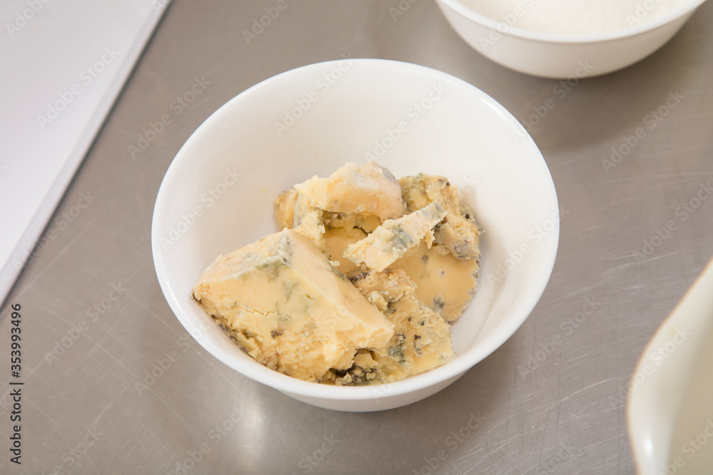 Delicious blue cheese in a white ceramic bowl. Delicious blue cheese in a white ceramic bowl.