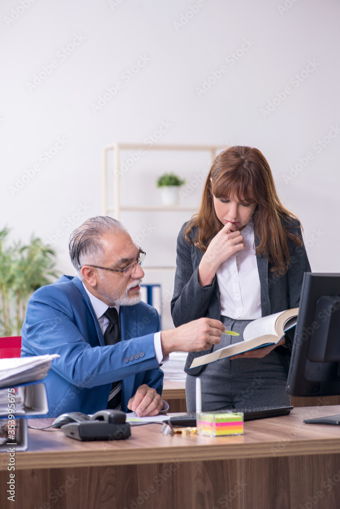 Two employees working in the office Two employees working in the office