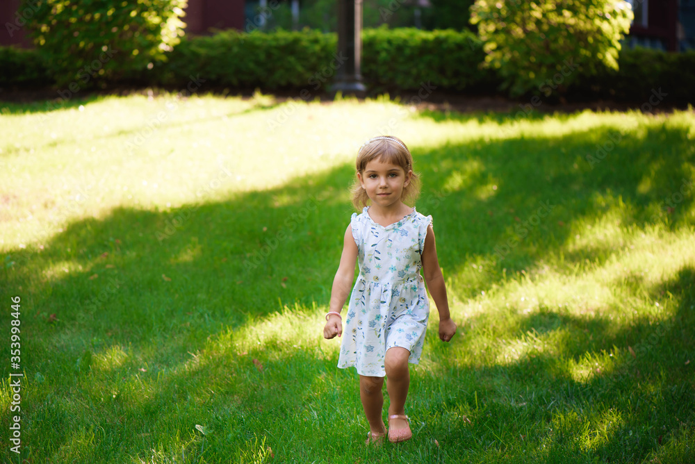 Sweet little girl outdoors with curly hair in the wind. Sweet little girl outdoors with curly hair in the wind.