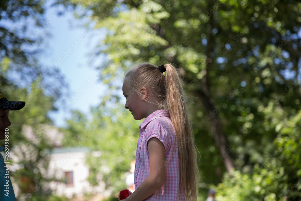 Portrait of a cute little girl in a park. Portrait of a cute little girl in a park.