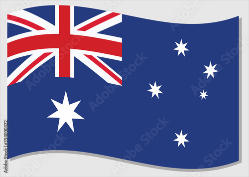 Waving flag of Australia vector graphic. Waving Australian flag illustration. Australia country flag wavin in the wind is a symbol of freedom and independence.