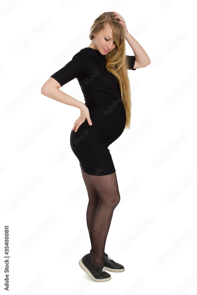Pregnant woman in black dress, with long hair, posing Pregnant woman in black dress, with long hair, posing