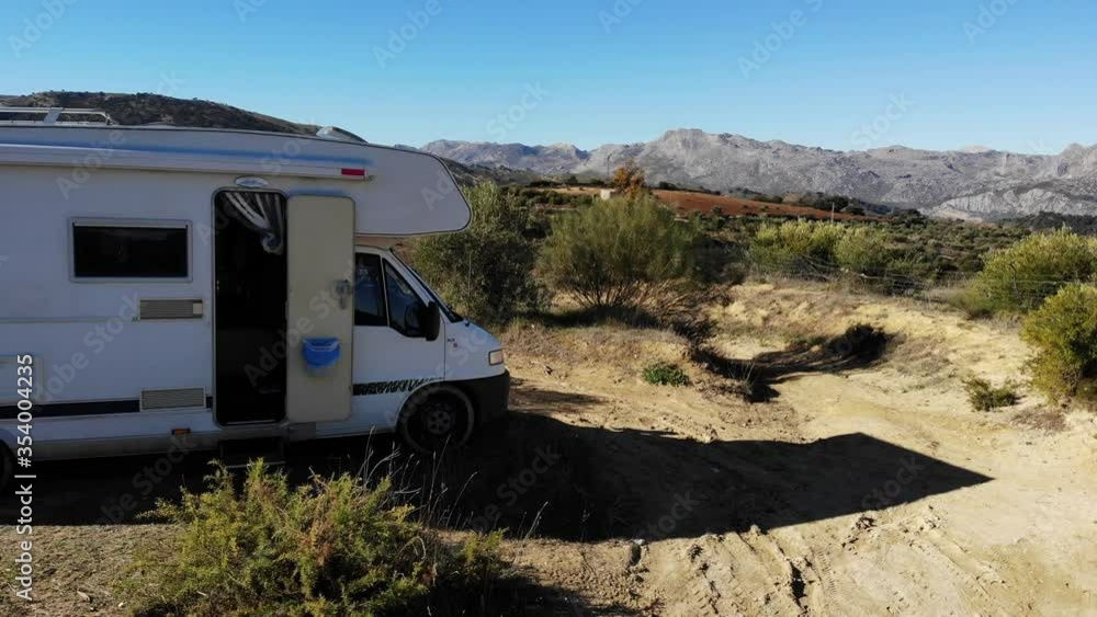 Aerial view. Motorhome camper car on roadside in spanish mountain nature. Travelling in caravan Aerial view. Motorhome camper car on roadside in spanish mountain nature. Travelling in caravan