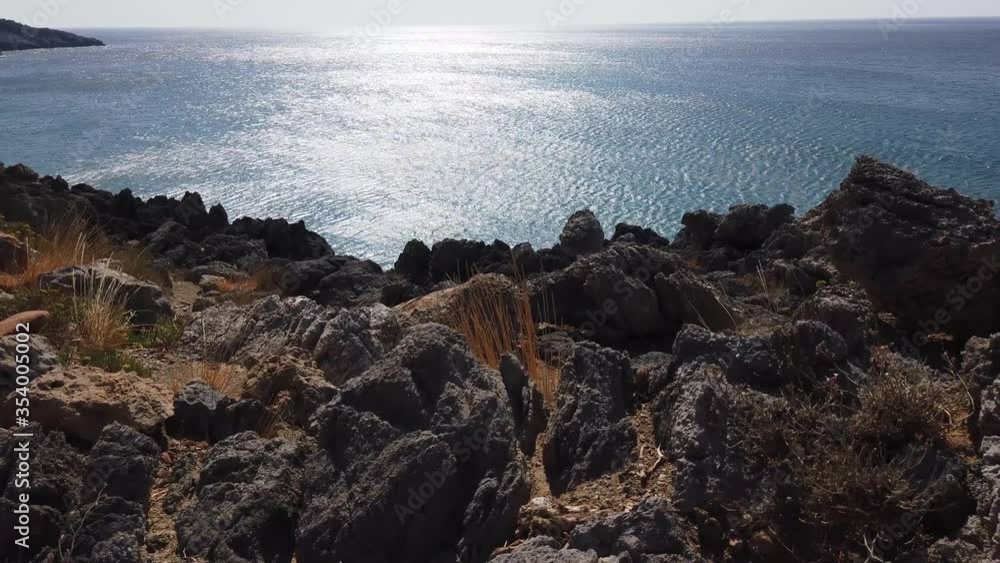 Top view of the sea surface. Weak waves, ripples on the turquoise surface of the water. Pure clear water and the rocky bottom of a volcanic island. Top view of the sea surface. Weak waves, ripples on the turquoise surface of the water. Pure clear water and the rocky bottom of a volcanic island.
