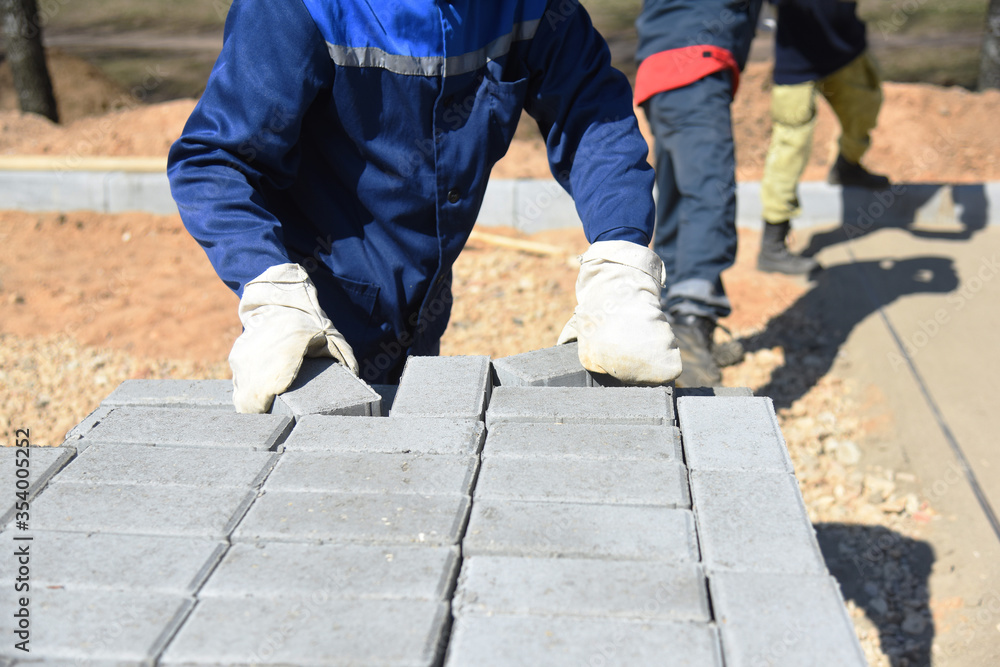 The builder takes concrete blocks from the pallet. The builder takes concrete blocks from the pallet.