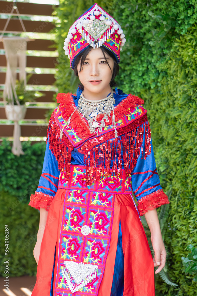 portrait of Hmong young woman in tradition Hmong costume for young girl; Asian ethnic tribal people in traditional colorful clothing culture of Hmong or Miao people in east Asia and southeast Asia portrait of Hmong young woman in tradition Hmong costume for young girl; Asian ethnic tribal people in traditional colorful clothing culture of Hmong or Miao people in east Asia and southeast Asia