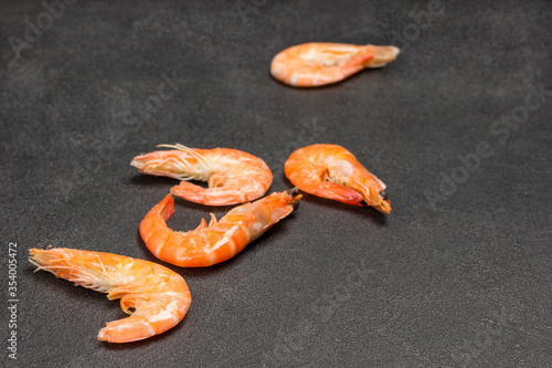 Orange shrimp on black background. Cjpy space. photo