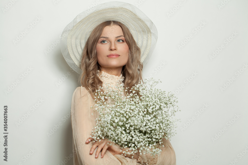Perfect lady in white hat holding flowers, portrait Perfect lady in white hat holding flowers, portrait
