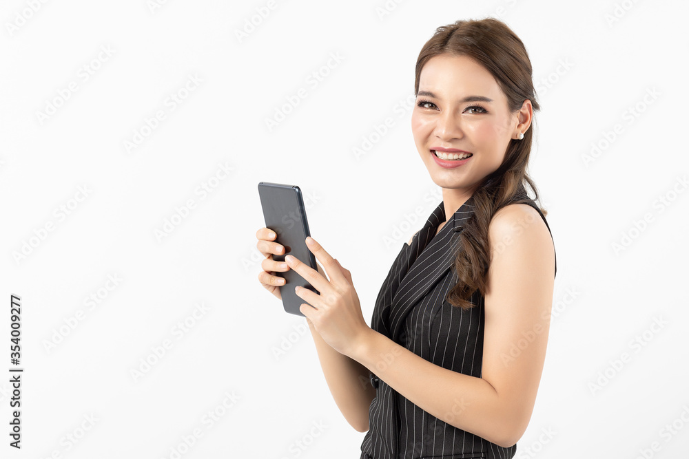 Portrait of happy young asian business woman in casual black and white clothes using digital tablet isolated on white background. Modern technologies and business, Youth and technology Portrait of happy young asian business woman in casual black and white clothes using digital tablet isolated on white background. Modern technologies and business, Youth and technology
