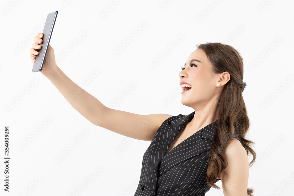 Portrait of happy young asian business woman in casual black and white clothes using digital tablet isolated on white background. Modern technologies and business, Youth and technology Portrait of happy young asian business woman in casual black and white clothes using digital tablet isolated on white background. Modern technologies and business, Youth and technology