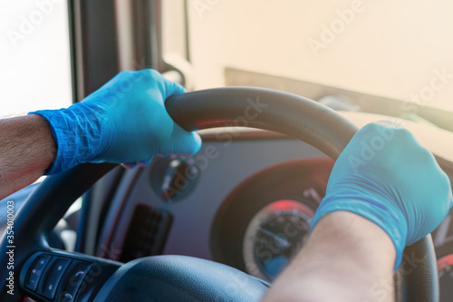 Trucker driving with latex gloves as a precaution against infections