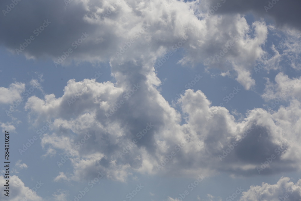 Obraz premium white fluffy clouds in the blue sky.