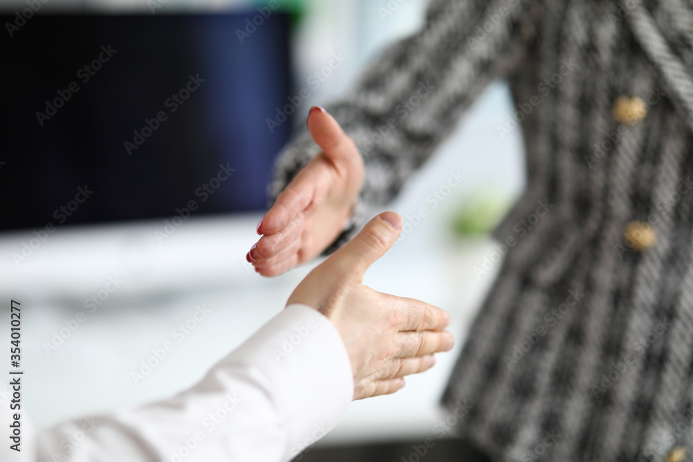 Man and woman extend their hands in greeting Man and woman extend their hands in greeting