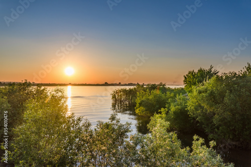Sunset over the Siberian river on a warm spring evening