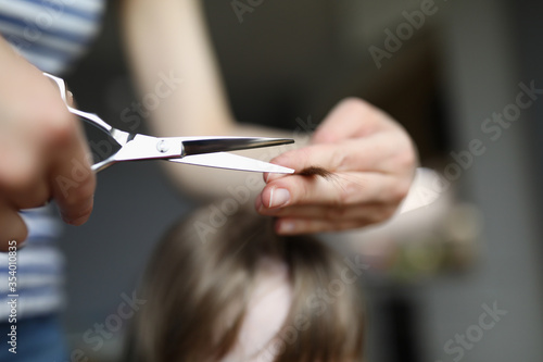 Mom cuts baby hair with scissors home, hairstyle