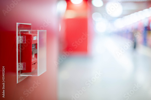 The red fire alarm switch on the red wall at the Bangkok subway.