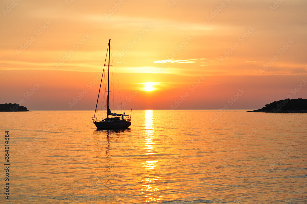Sailboat at sunset.