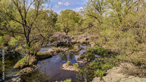 The landscape park of the Ukrainian castle Radomysl with waterfalls, islands and rare plants on a spring day. Museum of Ukrainian Medic and Politics Olga Bogomolets