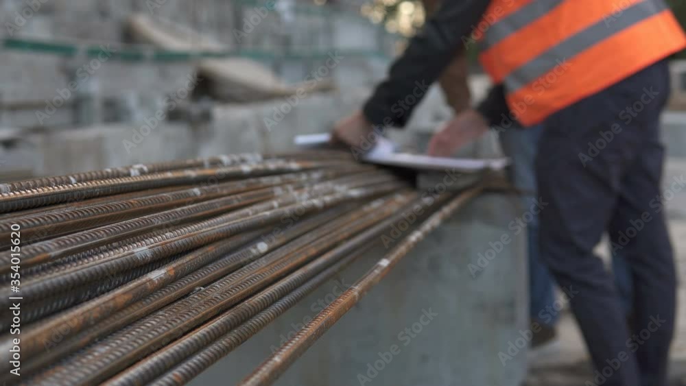 Business engineering at a construction site. Discussion of the construction drawing in the field on the construction of a high-rise building. Business engineering at a construction site. Discussion of the construction drawing in the field on the construction of a high-rise building.