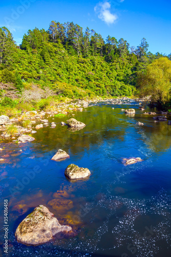 Fototapeta Naklejka Na Ścianę i Meble -   Shallow river with a rocky bed