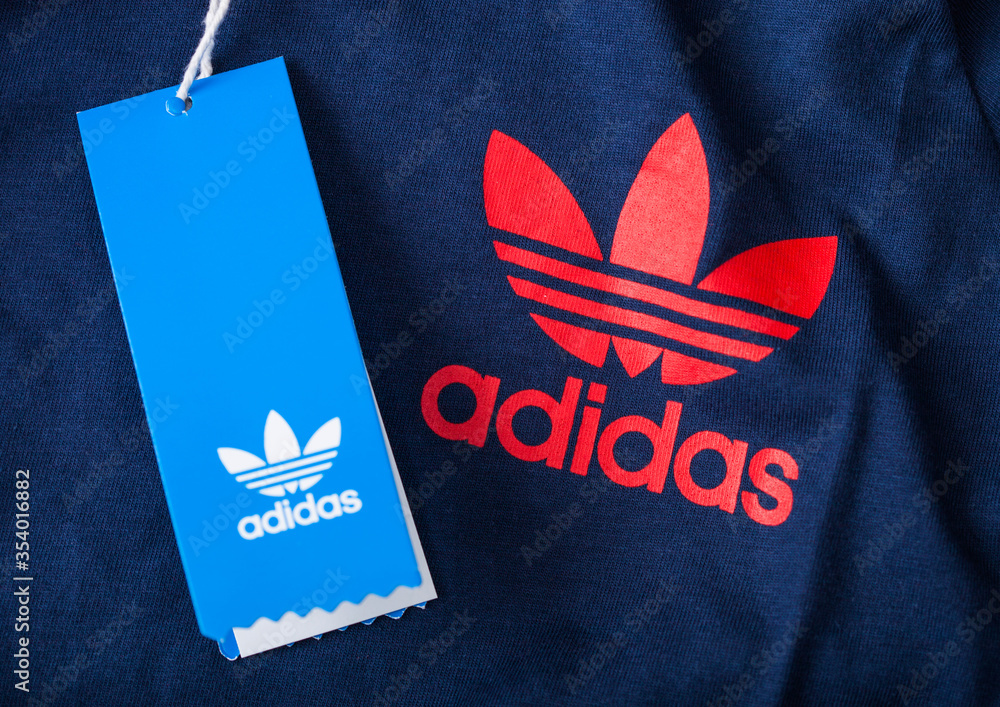 LONDON, UK - JUNE 05, 2019: Adidas Originals Label red color on blue fabric  with shopping tag.German multinational corporation. Stock Photo | Adobe  Stock