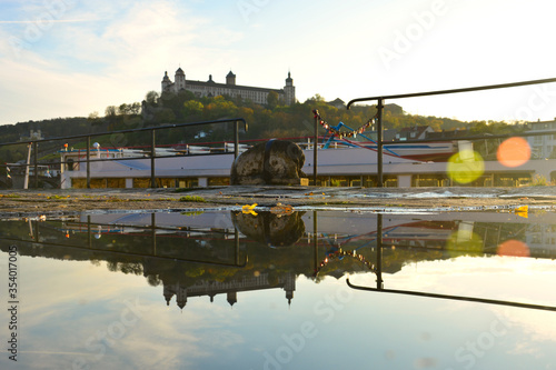 Würzburg Festung Marienberg mit einer Spiegelung in einer Pfütze im Sommer, Würzburg, Franken, Bayern, Deutschland photo