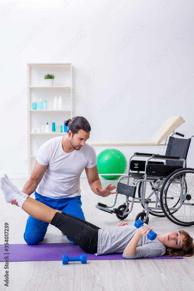 Woman in wheel-chair doing sport exercises with personal coach Woman in wheel-chair doing sport exercises with personal coach